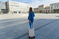 Woman traveler with suitcase at the railway station in Krakow