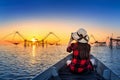 Woman traveler take a photo to fishing dip nets at Pakpra in Phatthalung, Thailand Royalty Free Stock Photo