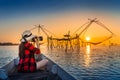 Woman traveler take a photo to fishing dip nets at Pakpra in Phatthalung, Thailand Royalty Free Stock Photo