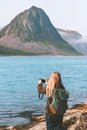Woman traveler taking photo by camera exploring Norway