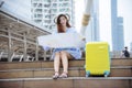 Woman traveler tourism with travel suitcase on vacation summer dream asian destination holding map for tourist looking on journey Royalty Free Stock Photo