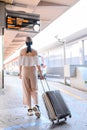 Woman traveler tourist walking with luggage at train station. Active and travel lifestyle concept Royalty Free Stock Photo