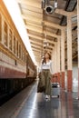 Woman traveler tourist walking with luggage at train station. Active and travel lifestyle concept Royalty Free Stock Photo