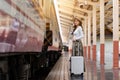 Woman traveler tourist walking with luggage at train station. Active and travel lifestyle concept Royalty Free Stock Photo