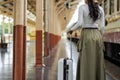 Woman traveler tourist walking with luggage at train station. Active and travel lifestyle concept Royalty Free Stock Photo