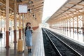 Woman traveler tourist walking with luggage at train station. Active and travel lifestyle concept Royalty Free Stock Photo