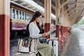 Woman traveler tourist walking with luggage at train station. Active and travel lifestyle concept Royalty Free Stock Photo