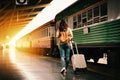 Woman traveler tourist walking with luggage at train station Royalty Free Stock Photo