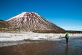 Woman traveler tramping in New Zealand, hiking and walking to the Mount Ngauruhoe, active volcano with red peak, New Zealand Royalty Free Stock Photo