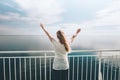 Woman traveler traveling by ferry sea happy raised hands Royalty Free Stock Photo