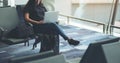 A woman traveler using laptop computer in the airport Royalty Free Stock Photo