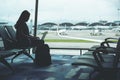 A woman traveler using laptop computer in the airport Royalty Free Stock Photo