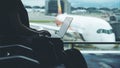 A woman traveler using laptop computer in the airport Royalty Free Stock Photo