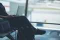 A woman traveler using laptop computer in the airport Royalty Free Stock Photo