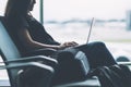 A woman traveler using laptop computer in the airport Royalty Free Stock Photo