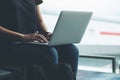 A woman traveler using laptop computer in the airport Royalty Free Stock Photo