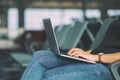 Woman traveler using laptop computer while sitting in the airport Royalty Free Stock Photo