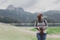 Woman traveler with vintage camera taking a photo Royalty Free Stock Photo