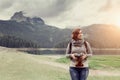 Woman traveler with vintage camera taking a photo Royalty Free Stock Photo