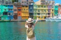 woman traveler visiting in Taiwan, Tourist with backpack and hat sightseeing in Keelung, Colorful Zhengbin Fishing Port, landmark