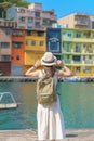 woman traveler visiting in Taiwan, Tourist with backpack and hat sightseeing in Keelung, Colorful Zhengbin Fishing Port, landmark