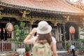 woman traveler visiting in Taiwan, Tourist with hat sightseeing in Longshan Temple, Chinese folk religious temple in Wanhua