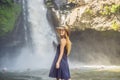 Woman traveler on a waterfall background. Ecotourism concept Royalty Free Stock Photo