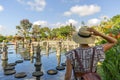 Woman traveler wearing white dress and straw hat at Taman Tirtagangga temple on Bali, Indonesia in a sunny day Royalty Free Stock Photo