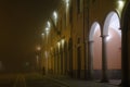 Woman travelerat station in foggy morning. Female tourist traveling alone: Voghera, Italy- February 03, 2020