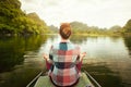 Woman traveling by boat on river amidst the scenic karst mountains Royalty Free Stock Photo