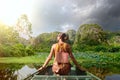 Woman traveling by boat on river amidst the scenic karst mountains in Ninh Binh province, Vietnam Royalty Free Stock Photo