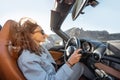 Woman traveling by cabriolet on the desert road