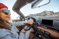 Woman traveling by cabriolet on the desert road