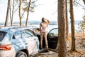 Woman traveling by car in the forest Royalty Free Stock Photo
