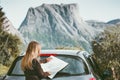 Woman traveling by car on road trip with map planning route Lifestyle concept adventure vacations Royalty Free Stock Photo