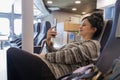 Woman traveling by ferry sitting smiling and watching mobile phone Royalty Free Stock Photo