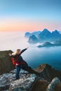 Woman traveling in Lofoten islands solo traveler on mountain cliff edge enjoying sunset view tourist hiking in Norway Royalty Free Stock Photo