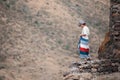 Woman traveling in the mountains, going ahead to the heights.