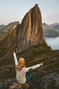 Woman traveling in Norway enjoying Segla mountain view adventure vacations