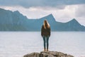 Woman traveling in Norway looking at sea and mountains view alone outdoor Royalty Free Stock Photo