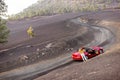 Woman with red cabriolet on the volcanic road