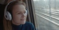 Woman traveling by train with favorite muisc