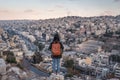 A woman traveller with backpack standing on top of the mountain in Amman city in Jordan, Arab