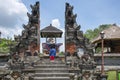 A woman traveller is enjoying the view of old cultural sculpture at the entrance of gate of heaven as a part of asian history in