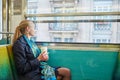 Woman travelling in a train of Parisian underground and drinking coffee Royalty Free Stock Photo
