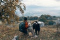 woman travels in the mountains with a dog walk friendship autumn