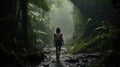 A woman trekker in the rain forest, in the rain, with difficulty