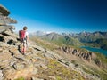Woman trekking in high altitude rocky mountain landscape. Summer adventures on the Italian French Alps Royalty Free Stock Photo