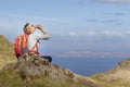 Woman trekking up to old man of storr on skye Royalty Free Stock Photo