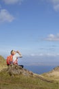 Woman trekking up to old man of storr on skye